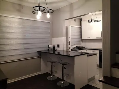 a kitchen with a counter and stools in it at Rhodesfield's Hidden Gem in Kempton Park