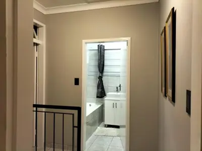 a bathroom with a sink and a bath tub at Rhodesfield's Hidden Gem in Kempton Park