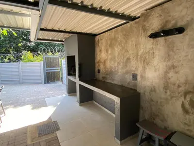 a patio with a table and a wooden ceiling at The Hideaway in Nelspruit