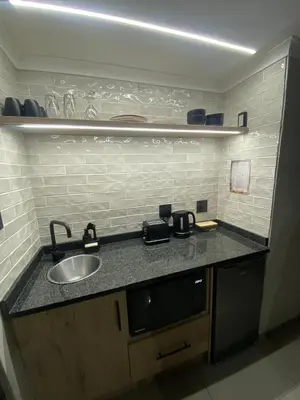 a kitchen with a sink and a counter top at The Hideaway in Nelspruit
