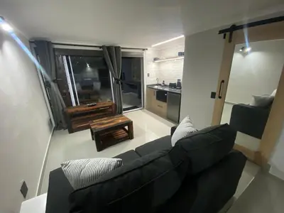 a living room with a couch and a table at The Hideaway in Nelspruit