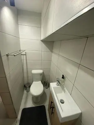 a small bathroom with a toilet and a sink at The Hideaway in Nelspruit