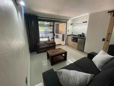 a living room with a couch and a table at The Hideaway in Nelspruit