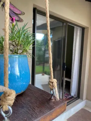 a blue vase sitting on a table with a rope at Baobab Guesthouse in Centurion