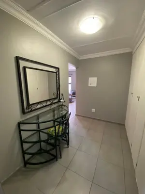 a dining room with a mirror and a table at Baobab Guesthouse in Centurion