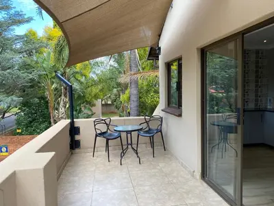 a patio with chairs and a table on a balcony at Baobab Guesthouse in Centurion