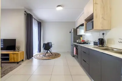 a kitchen with a sink and a counter top at Ground Floor Premium Suite in Midrand