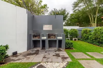 a garden with a table against a wall at Ground Floor Premium Suite in Midrand