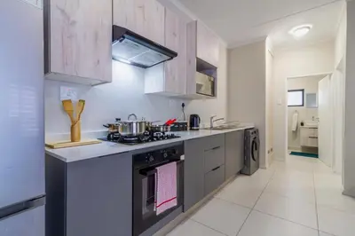 a kitchen with a stove top oven in a room at Ground Floor Premium Suite in Midrand