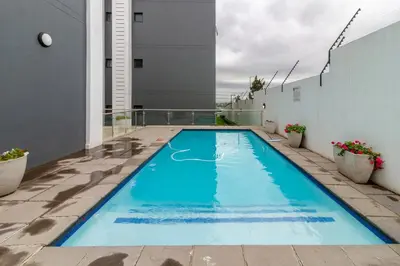 a swimming pool on the balcony of a building at Ground Floor Premium Suite in Midrand