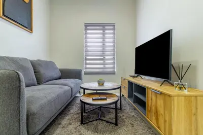 a living room with a couch and a flat screen tv at Ground Floor Premium Suite in Midrand