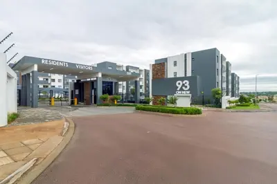 an empty street in front of a large building at Ground Floor Premium Suite in Midrand