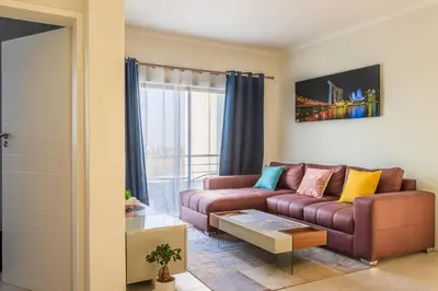 a living room with a couch and a table at Infinite Views Penthouse in Midrand