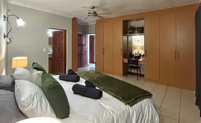 a bedroom with a large bed with two pillows on it at Fish Eagle Manor in Warmbaths