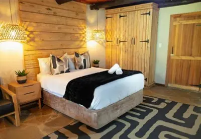 a bedroom with a large bed in a room at Silverlakes Farm Hotel in Pretoria