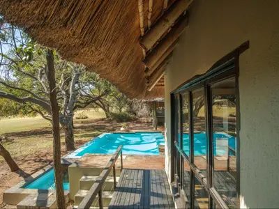 an external view of a house with a swimming pool at Kokobela Lodge in Phalaborwa