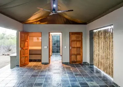 a hallway of a home with a ceiling fan at Jackalberry Ridge by Dream Resorts in Marloth Park