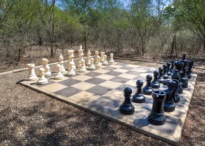 a chess set on a board in a park at Jackalberry Ridge by Dream Resorts in Marloth Park
