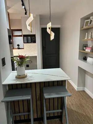 a kitchen with a counter and two stools at 191 Protea Estate in Midrand