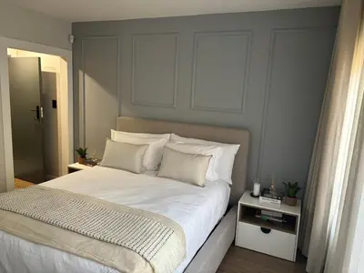 a bedroom with a bed with white sheets and pillows at 191 Protea Estate in Midrand