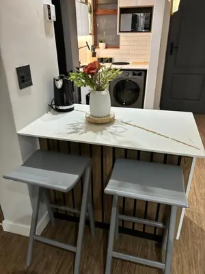 a small kitchen with a counter and two stools at 191 Protea Estate in Midrand