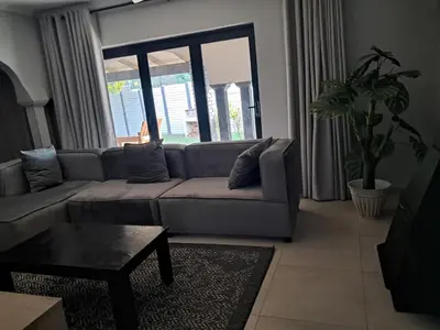 a living room with a couch and a table at Adam's Inn place in Hartbeespoort