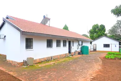a white house with a red roof at Sublime Home in Bela-Bela