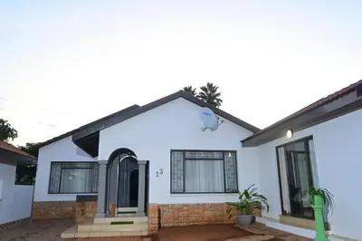 a house with white walls and windows at Sublime Home in Bela-Bela
