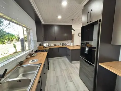 a large kitchen with a sink and a counter at Shamba Self-Catering in Pretoria