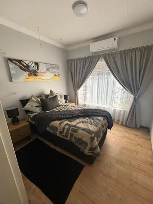 a bedroom with a bed and a window at Shamba Self-Catering in Pretoria