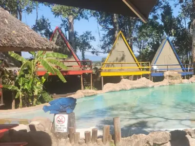 a pool at a resort with a water slide at Beach Island Graskop in Graskop