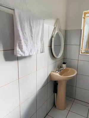 a bathroom with a sink and a mirror at Ekhaya Manor in Polokwane