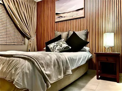 a bedroom with a bed with pillows on it at Little Swift 2 in Secunda