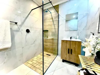 a bathroom with a shower and a sink at Little Swift 2 in Secunda