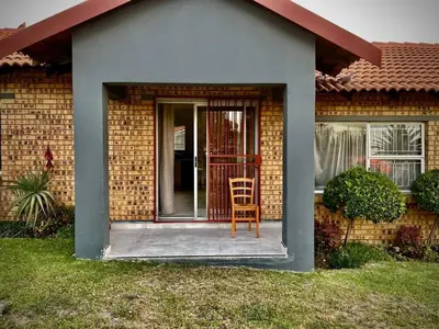 a chair sitting on the front porch of a house at Little Swift 2 in Secunda