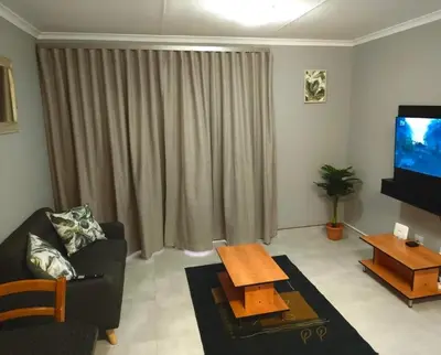 a living room with a couch and a tv at Little Swift 2 in Secunda