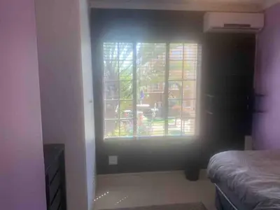 a bedroom with a window and a bed in a room at Imani's Retreat in Midrand