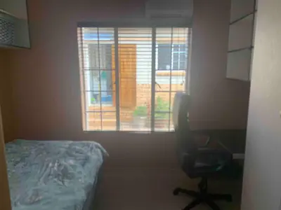 a room with a chair in front of a window at Imani's Retreat in Midrand