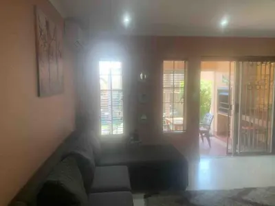 a living room with a couch and a table at Imani's Retreat in Midrand