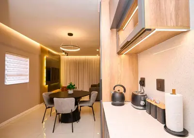 a living room with a table and chairs in a room at The Oasis, Unit N110 @ Glen Park in Pretoria