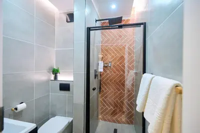 a shower with a glass door in a bathroom at The Oasis, Unit N110 @ Glen Park in Pretoria