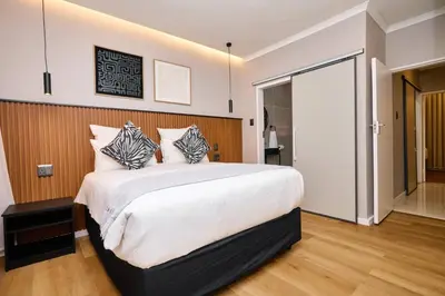 a bedroom with a large white bed with pillows at The Oasis, Unit N110 @ Glen Park in Pretoria