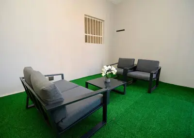 a living room with two chairs and a couch and a table at The Oasis, Unit N110 @ Glen Park in Pretoria