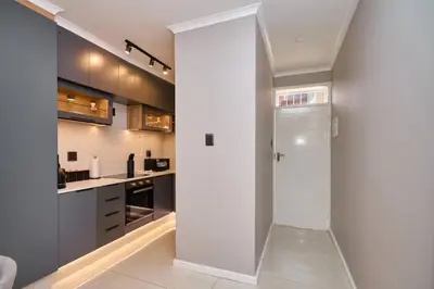 a hallway with a door leading into a kitchen at The Oasis, Unit N110 @ Glen Park in Pretoria