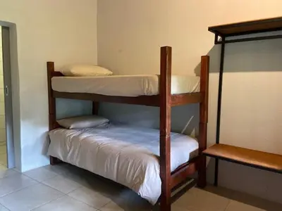 two bunk beds in a small room with at Ons Plek Accommodation in Hazyview