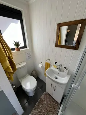 a bathroom with a toilet and a sink and a mirror at Paradise & Private Padel Court in Dinokeng Game Reserve in Hammanskraal