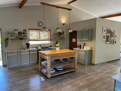 a large kitchen with a wooden table in it at Paradise & Private Padel Court in Dinokeng Game Reserve in Hammanskraal