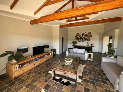 a living room with a couch and a tv at Paradise & Private Padel Court in Dinokeng Game Reserve in Hammanskraal
