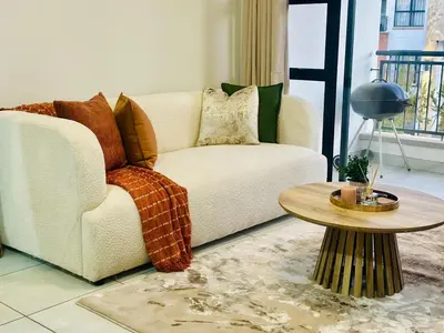 a living room with a couch and a table at Beach-Style Bliss at The Blyde in Pretoria