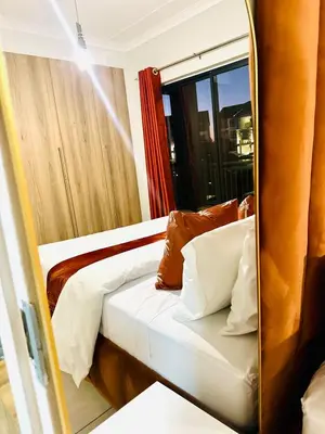 a mirror reflection of a bed in a room at Beach-Style Bliss at The Blyde in Pretoria